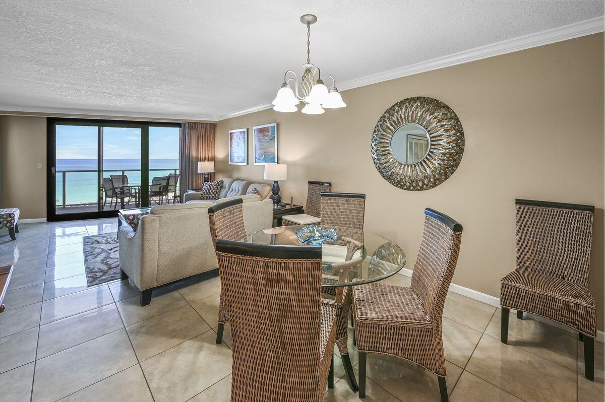 4252 Beachside 2, Unit 252 Miramar Beach, FL 32550 - Photo 4 of 27 a dining room with furniture a chandelier and a rug