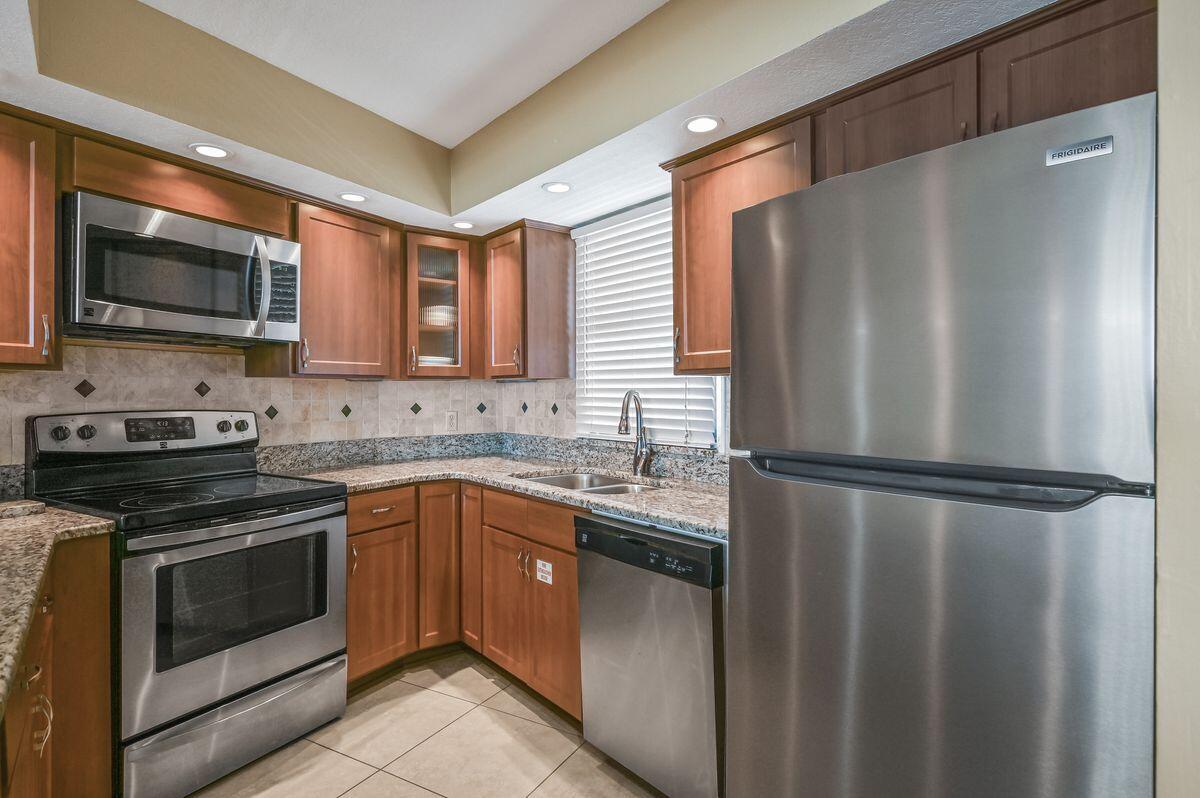 4252 Beachside 2, Unit 252 Miramar Beach, FL 32550 - Photo 8 of 27 a kitchen with a refrigerator sink and microwave