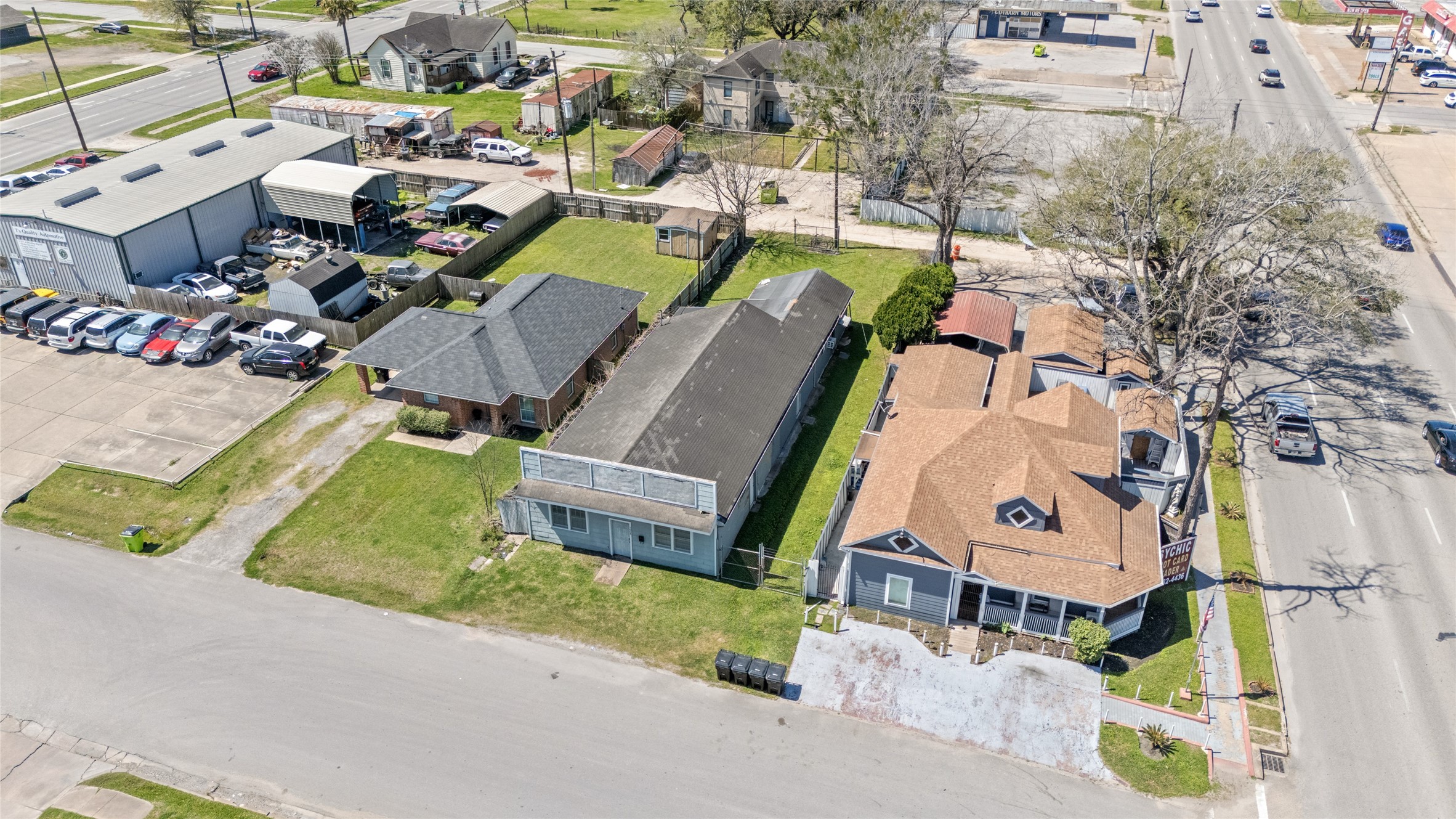 1004 Houston Street Rosenberg, TX 77471 - Photo 6 of 18 Spacious lot with existing tear-down structure, offering prime visibility and accessibility. The image highlights the lot's generous size, open yard space, and proximity to surrounding businesses and roadways—ideal for redevelopment or new construction.