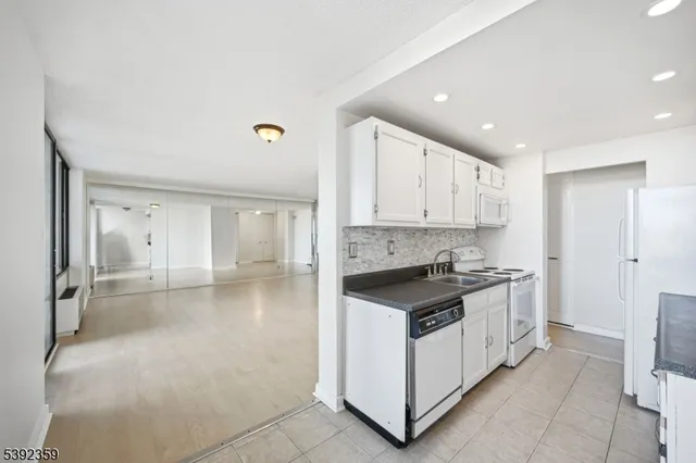 a kitchen with a stove a sink and a refrigerator