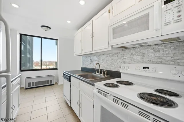 a kitchen that has a sink and a stove