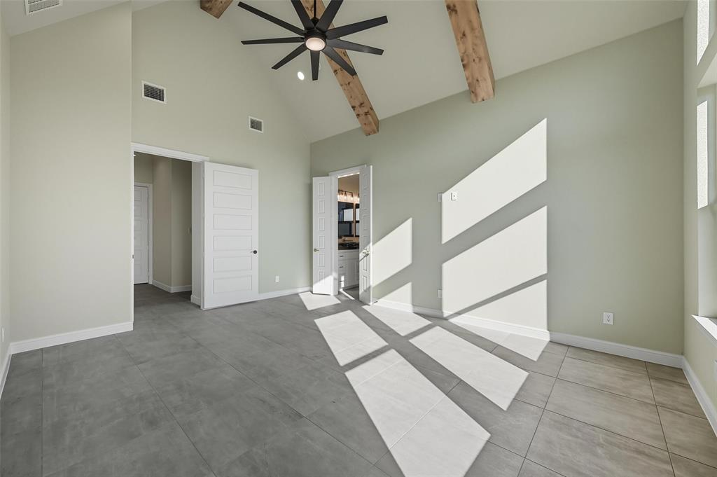 112 La Paloma Way Decatur, TX 76234 - Photo 19 of 37 Unfurnished bedroom with high vaulted ceiling, beamed ceiling, a ceiling fan, and ensuite bathroom