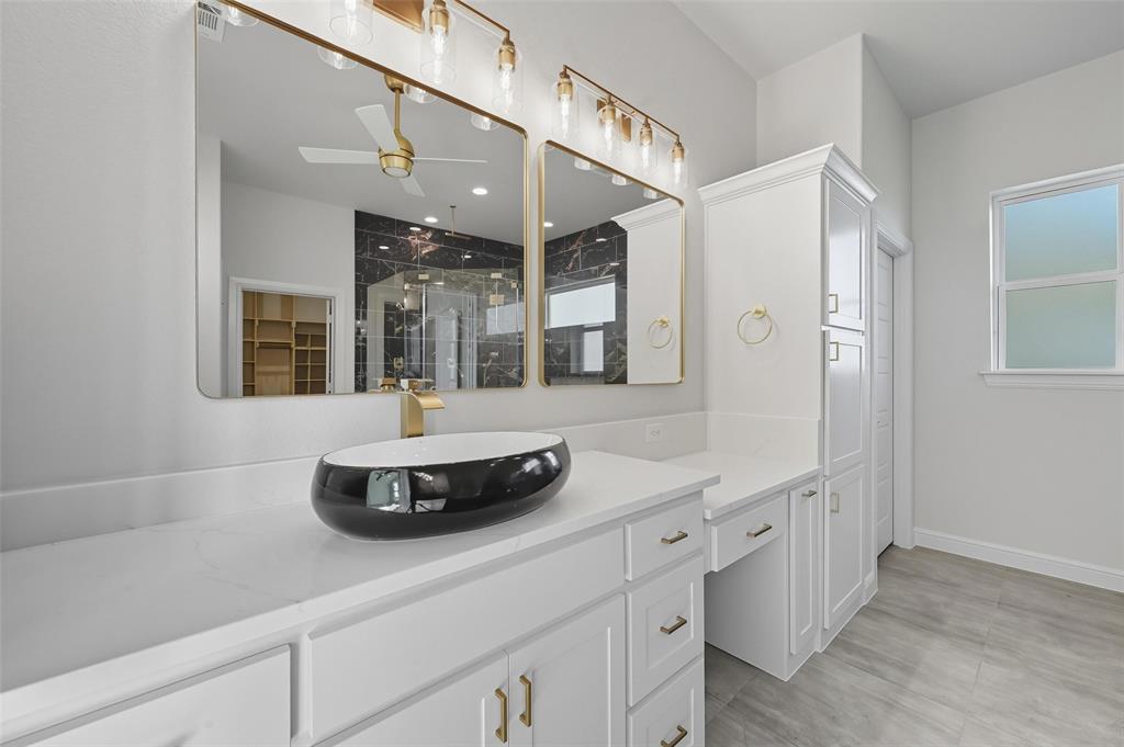 112 La Paloma Way Decatur, TX 76234 - Photo 20 of 37 Full bathroom with a shower stall, vanity, ceiling fan, and a walk in closet