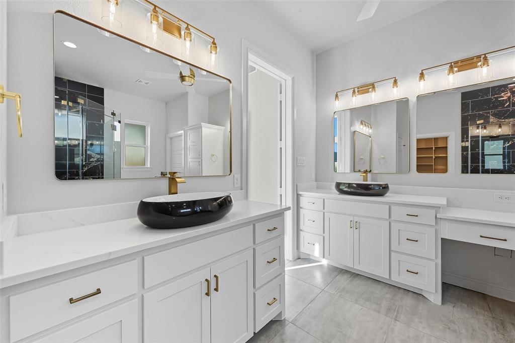 112 La Paloma Way Decatur, TX 76234 - Photo 21 of 37 Full bathroom with two vanities, a shower stall, and light tile patterned flooring