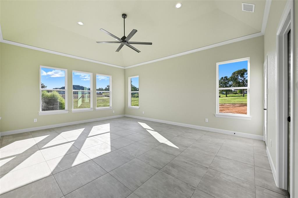 112 La Paloma Way Decatur, TX 76234 - Photo 24 of 37 Empty room with crown molding, recessed lighting, a ceiling fan, and light tile patterned floors