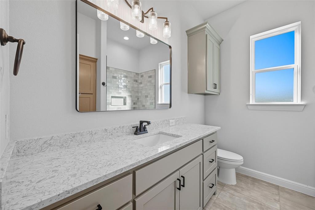 112 La Paloma Way Decatur, TX 76234 - Photo 29 of 37 Full bath featuring vanity, tiled shower, and light tile patterned floors