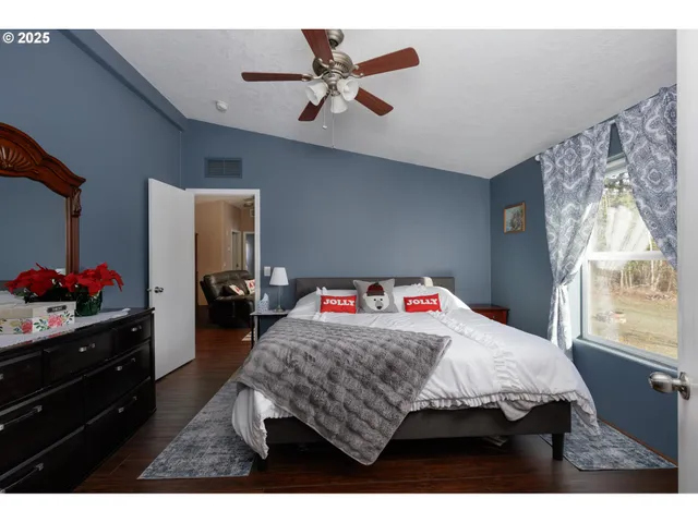 a bedroom that has a bed and a dresser in it