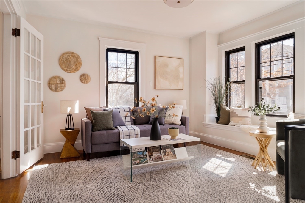 10 Washington Avenue, Unit 2 Waltham, MA 02453 - Photo 1 of 26 a living room with furniture and a large window