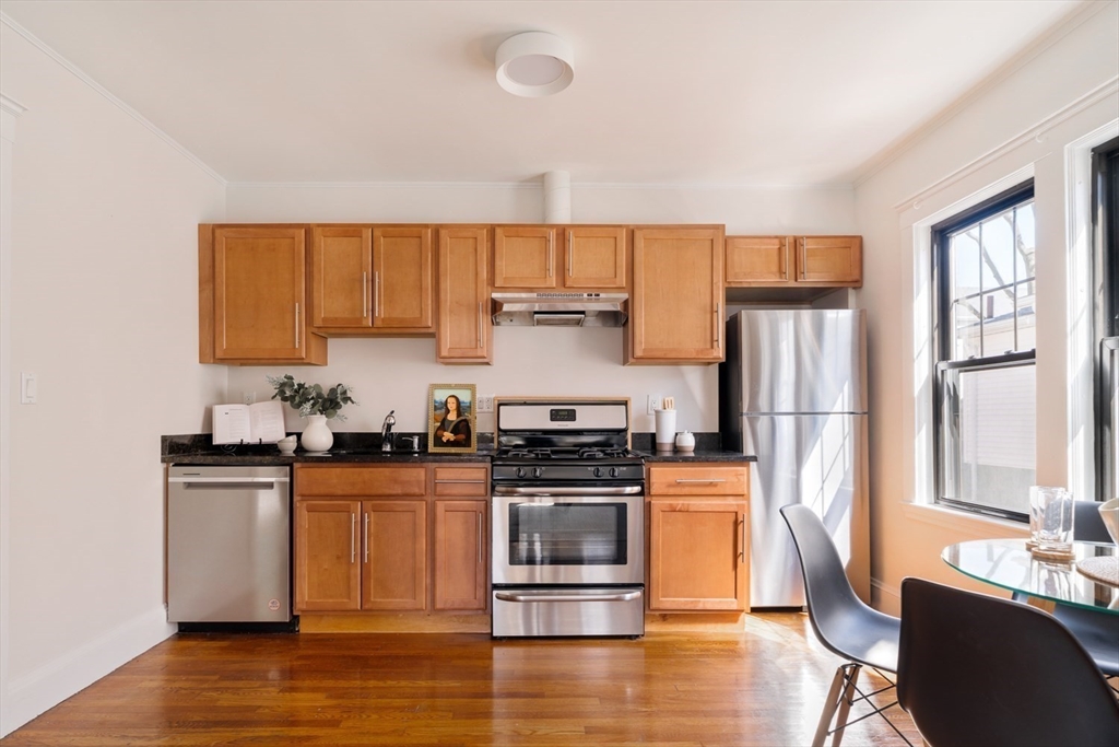 10 Washington Avenue, Unit 2 Waltham, MA 02453 - Photo 13 of 26 a kitchen with a stove a sink and a microwave