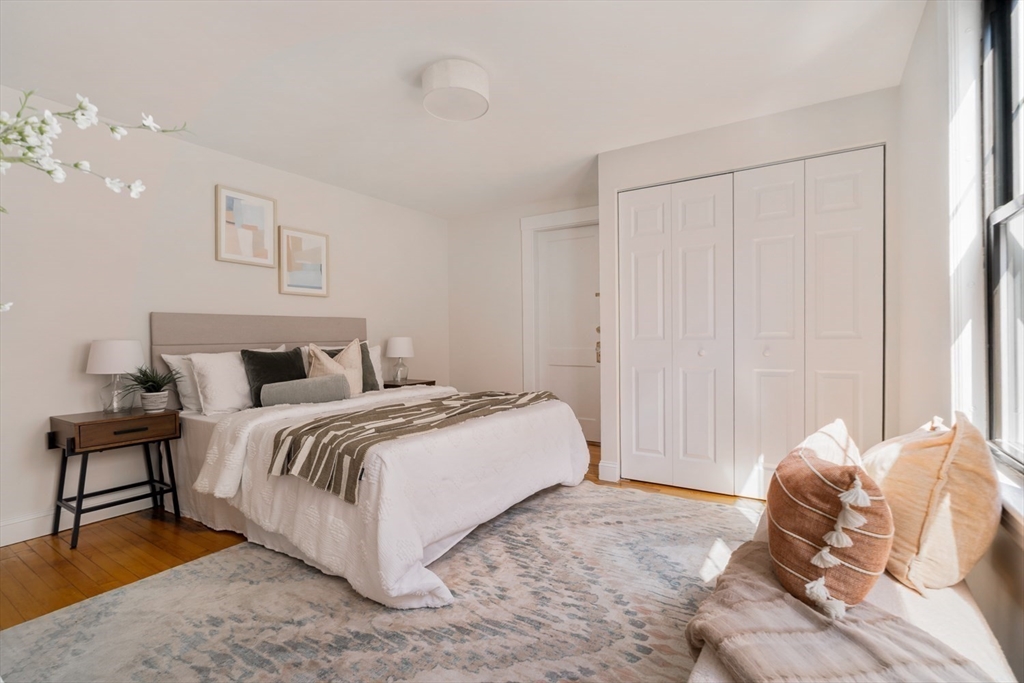 10 Washington Avenue, Unit 2 Waltham, MA 02453 - Photo 14 of 26 a bed room with a bed and a night stand