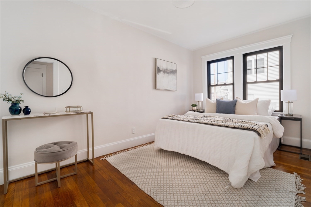 10 Washington Avenue, Unit 2 Waltham, MA 02453 - Photo 18 of 26 a living room with a bed furniture and a window