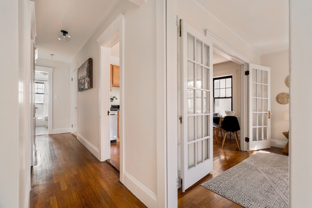 10 Washington Avenue, Unit 2 Waltham, MA 02453 - Photo 4 of 26 a view of a livingroom with wooden floor and furniture