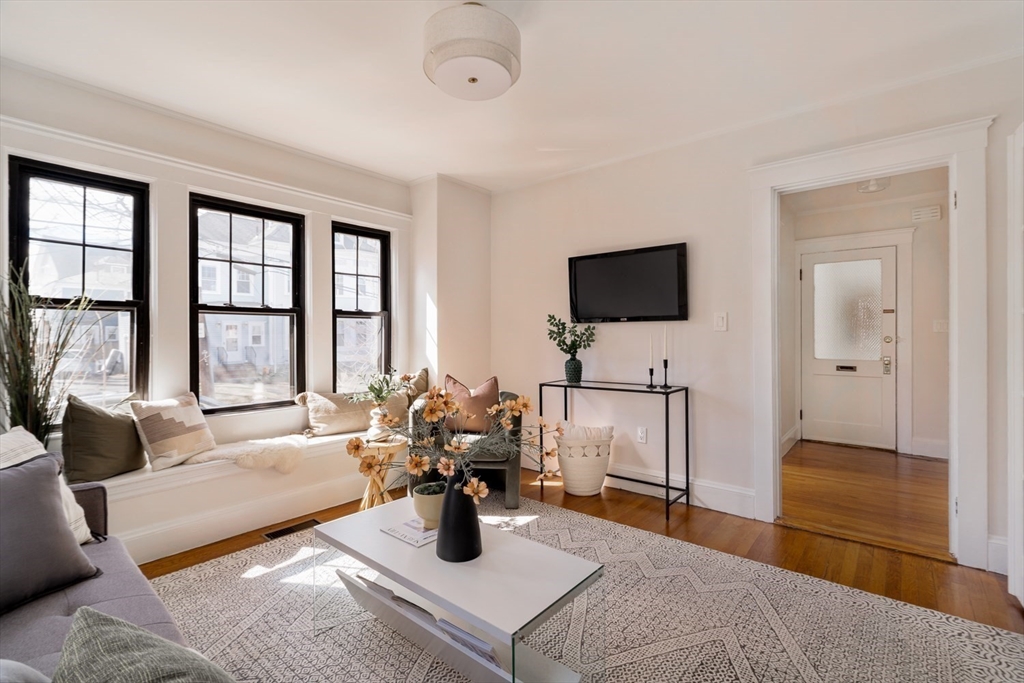 10 Washington Avenue, Unit 2 Waltham, MA 02453 - Photo 5 of 26 a living room with furniture and a flat screen tv