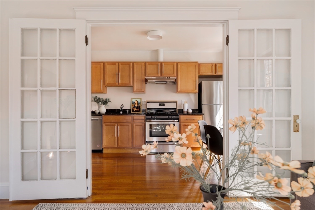 10 Washington Avenue, Unit 2 Waltham, MA 02453 - Photo 10 of 26 a kitchen with a refrigerator and white cabinets