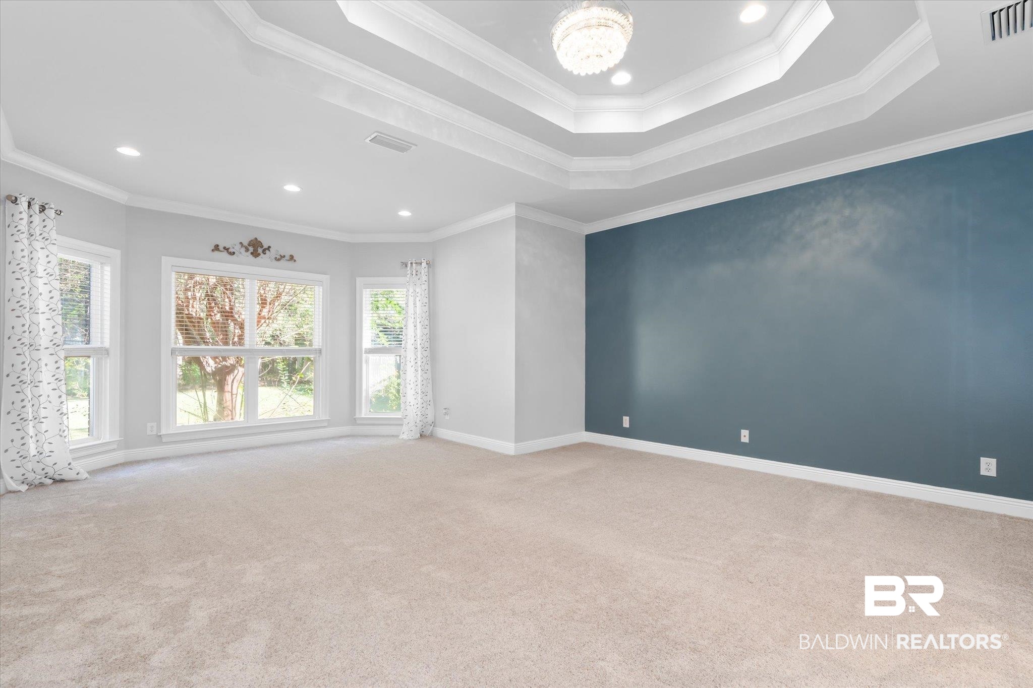 10730 Flagstone Drive Mobile, AL 36608 - Photo 10 of 20 Empty room featuring ornamental molding, light colored carpet, and a raised ceiling