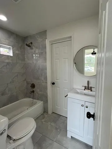 a bathroom with a toilet a sink and bathtub