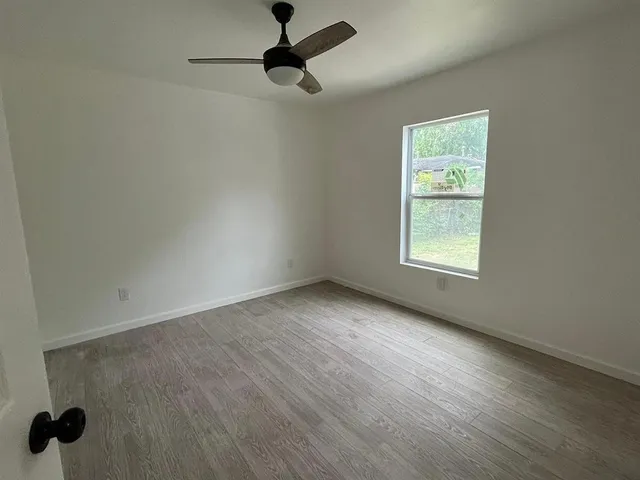 an empty room with windows and closet