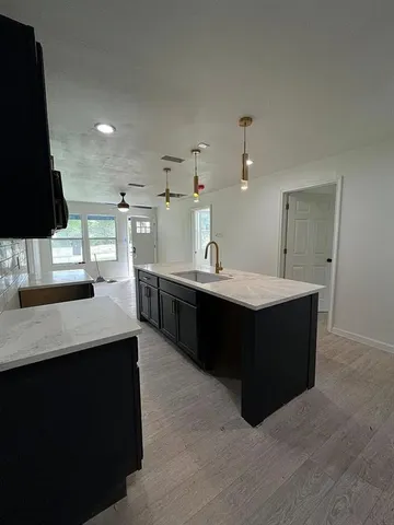 a kitchen with a sink and a stove
