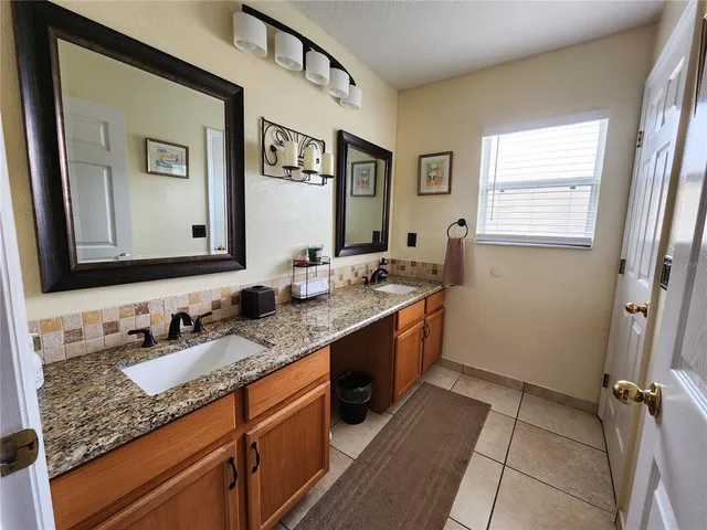 a bathroom with a granite countertop sink mirror and a