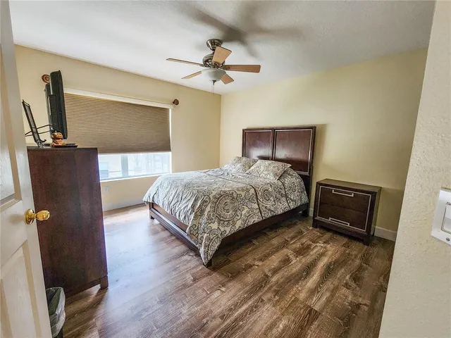 a bedroom with a bed and a mirror