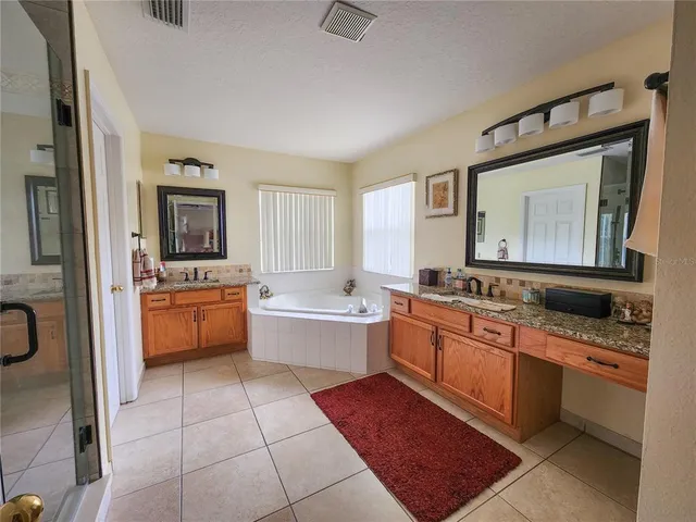 a large kitchen with a sink and cabinets