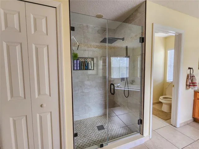 a bathroom with a glass shower door