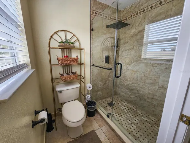 a bathroom with a toilet and a shower
