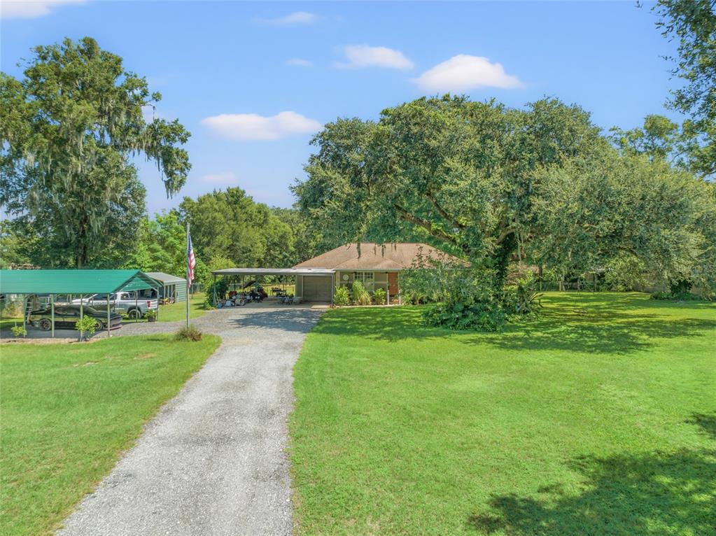 8634 Oliver Road Zephyrhills, FL 33540 - Photo 1 of 1 Your own piece of paradise! Driveway as you enter the electronic gate to the home