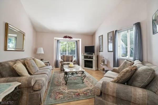 a living room with furniture large window and a flat screen tv