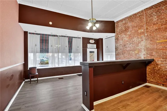 a view of a room with wooden floor
