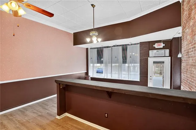 an entryway with a door and wooden floor