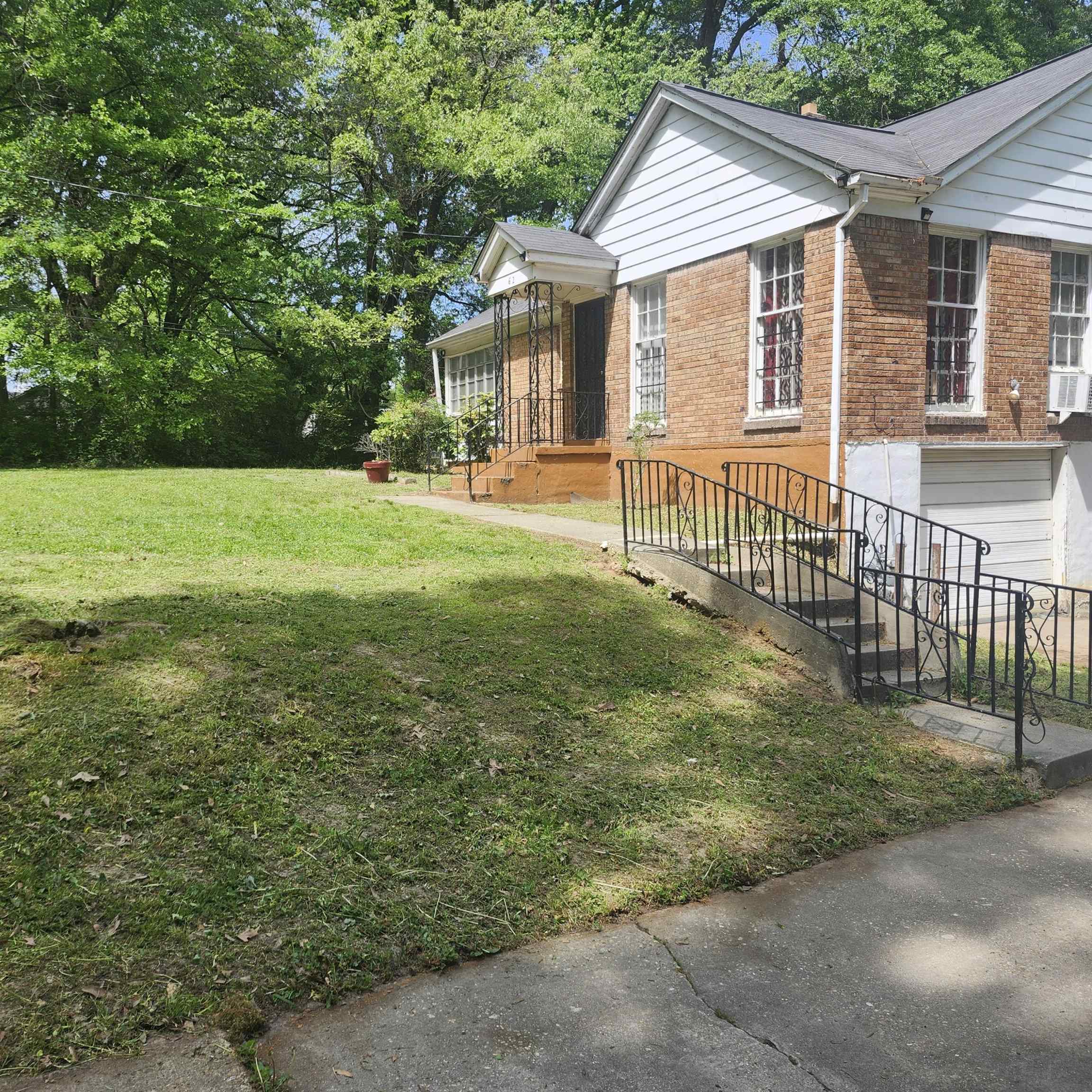 62 Eastman Road Memphis, TN 38109 - Photo 2 of 2 Brick exterior featuring white siding gables and a covered entry