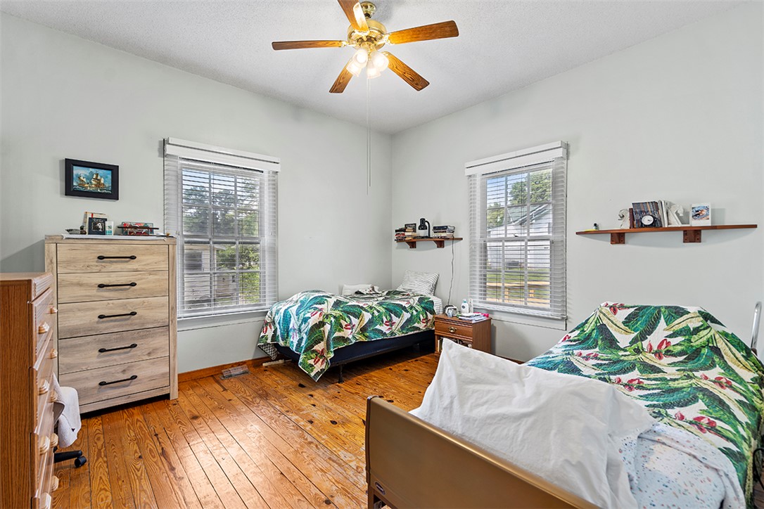 200 Louisiana Street Honea Path, SC 29654 - Photo 7 of 13 Hardwood floors and generous natural light define this cozy bedroom.