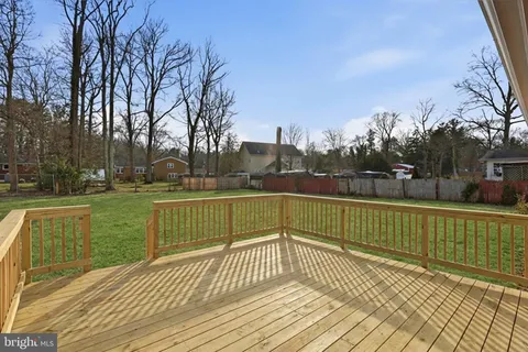 a view of a yard with wooden deck