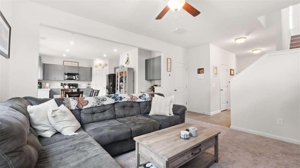 13 Maycroft Court Rome, GA 30161 - Photo 11 of 28 a living room with furniture a rug and kitchen view