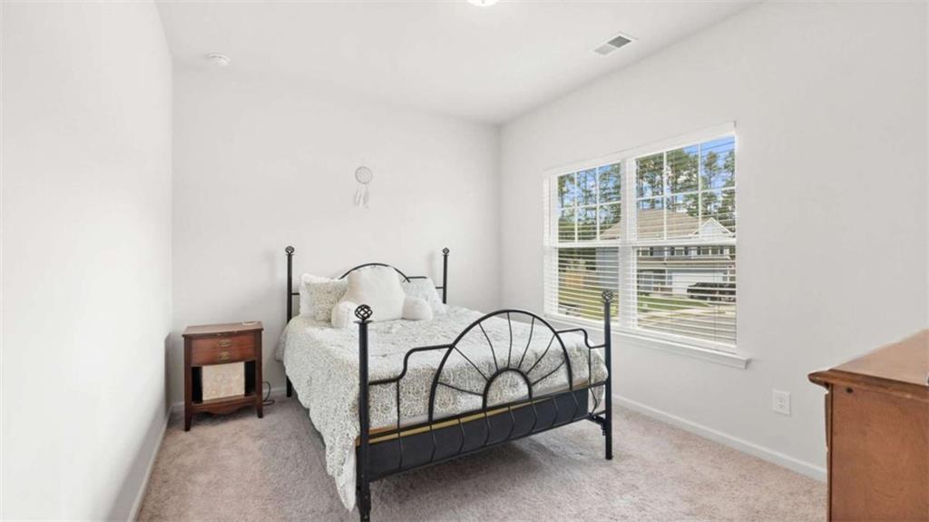 13 Maycroft Court Rome, GA 30161 - Photo 15 of 28 a bed sitting in a bedroom next to a window