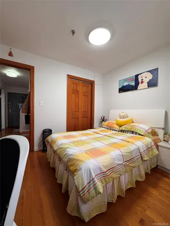 a bedroom with bed and a night stand