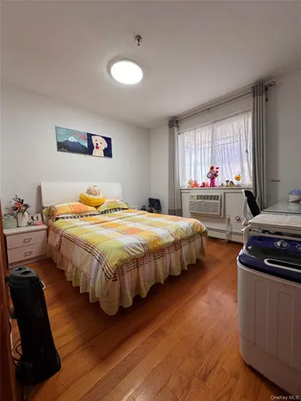 a bedroom with a bed and window