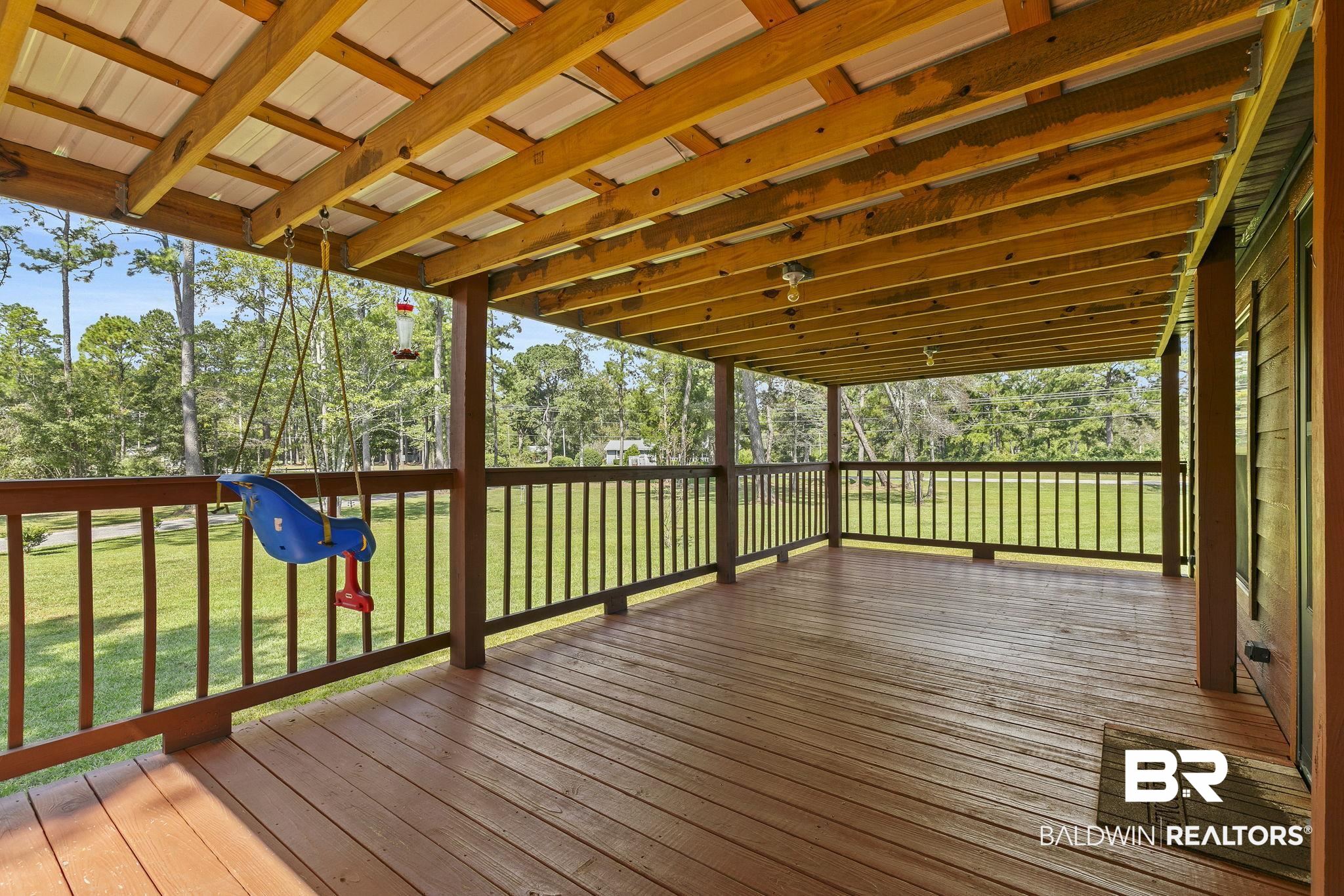 35641 County Road 39 Stapleton, AL 36578 - Photo 7 of 46 Wooden deck with a playground and a yard
