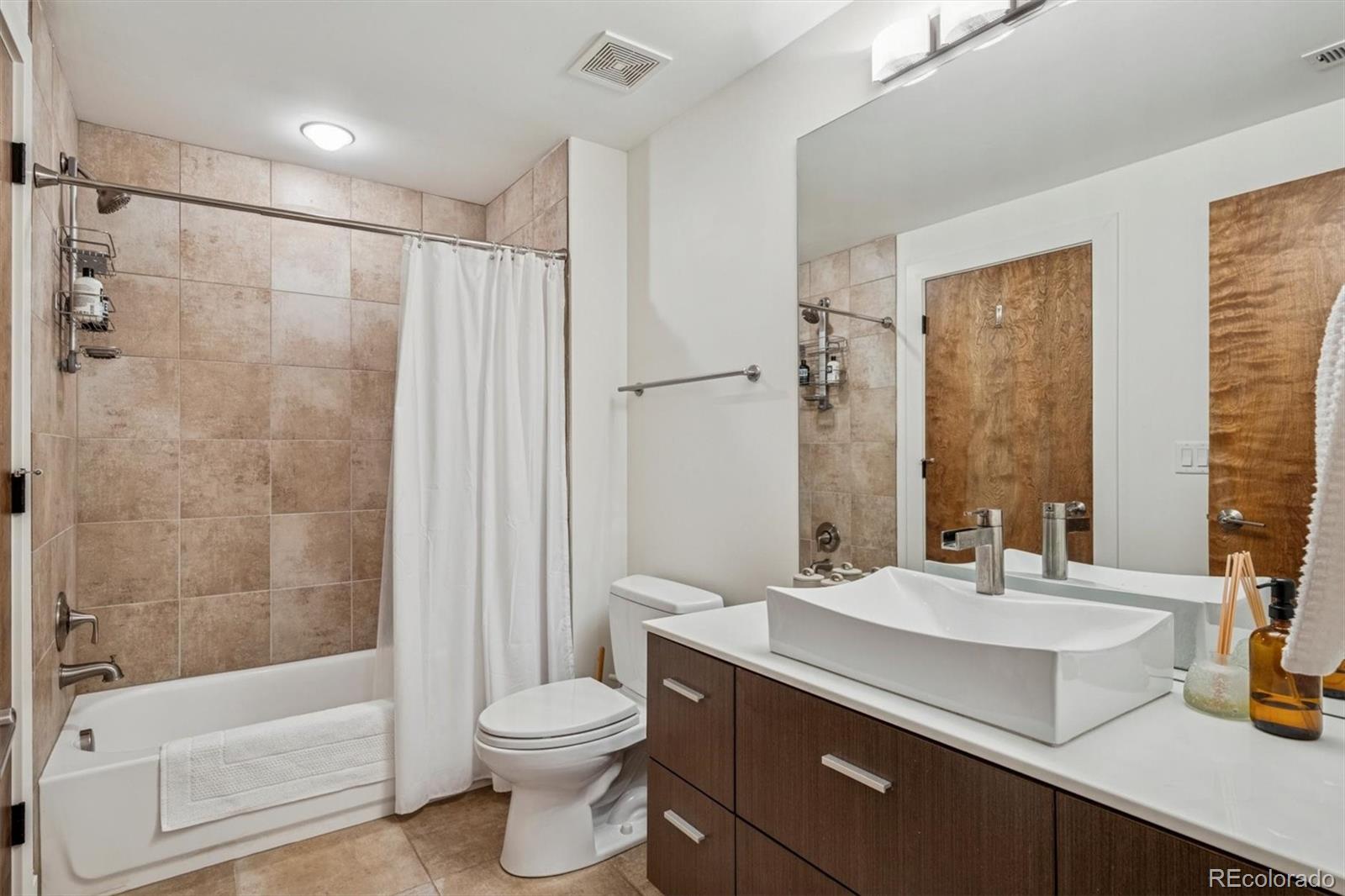 3422 Newton Street Denver, CO 80211 - Photo 11 of 37 a bathroom with a sink a toilet and shower