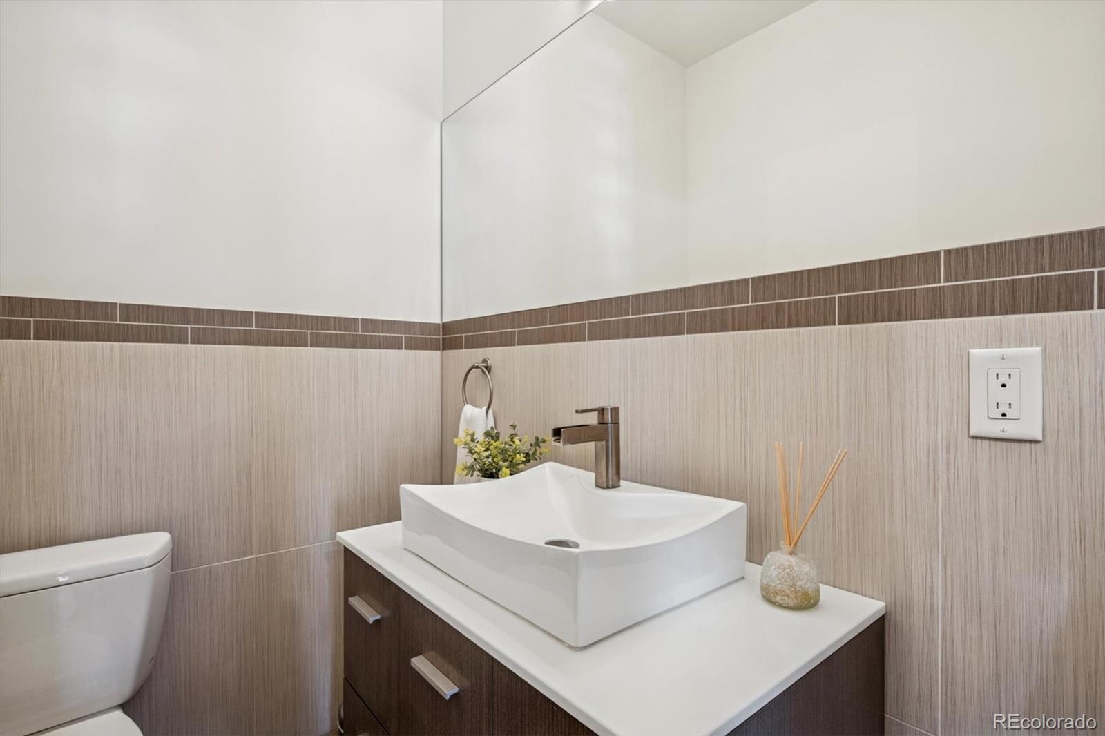 3422 Newton Street Denver, CO 80211 - Photo 12 of 37 a bathroom with a sink a toilet and vanity