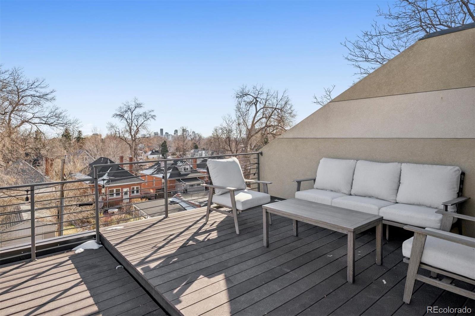 3422 Newton Street Denver, CO 80211 - Photo 20 of 37 a view of a balcony with wooden floor and outdoor seating