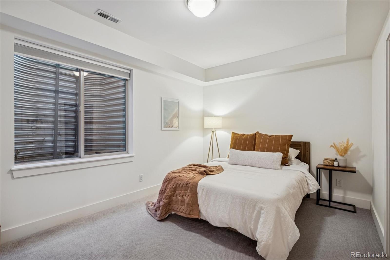 3422 Newton Street Denver, CO 80211 - Photo 27 of 37 a bedroom with a bed and a window