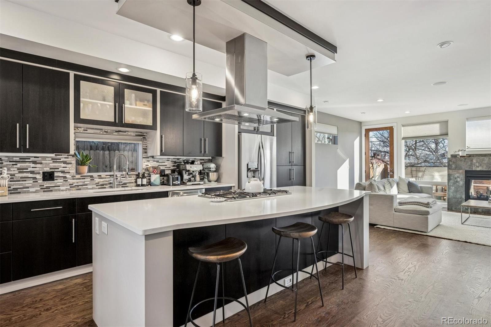 3422 Newton Street Denver, CO 80211 - Photo 8 of 37 a kitchen with a sink a counter space appliances and cabinets