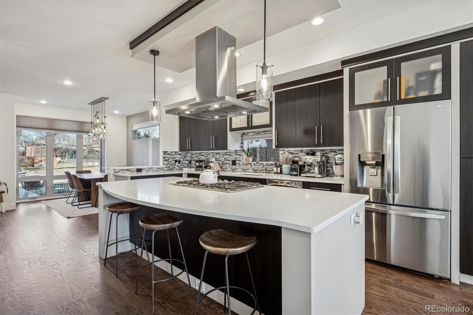 3422 Newton Street Denver, CO 80211 - Photo 9 of 37 a kitchen with stainless steel appliances a sink stove and refrigerator