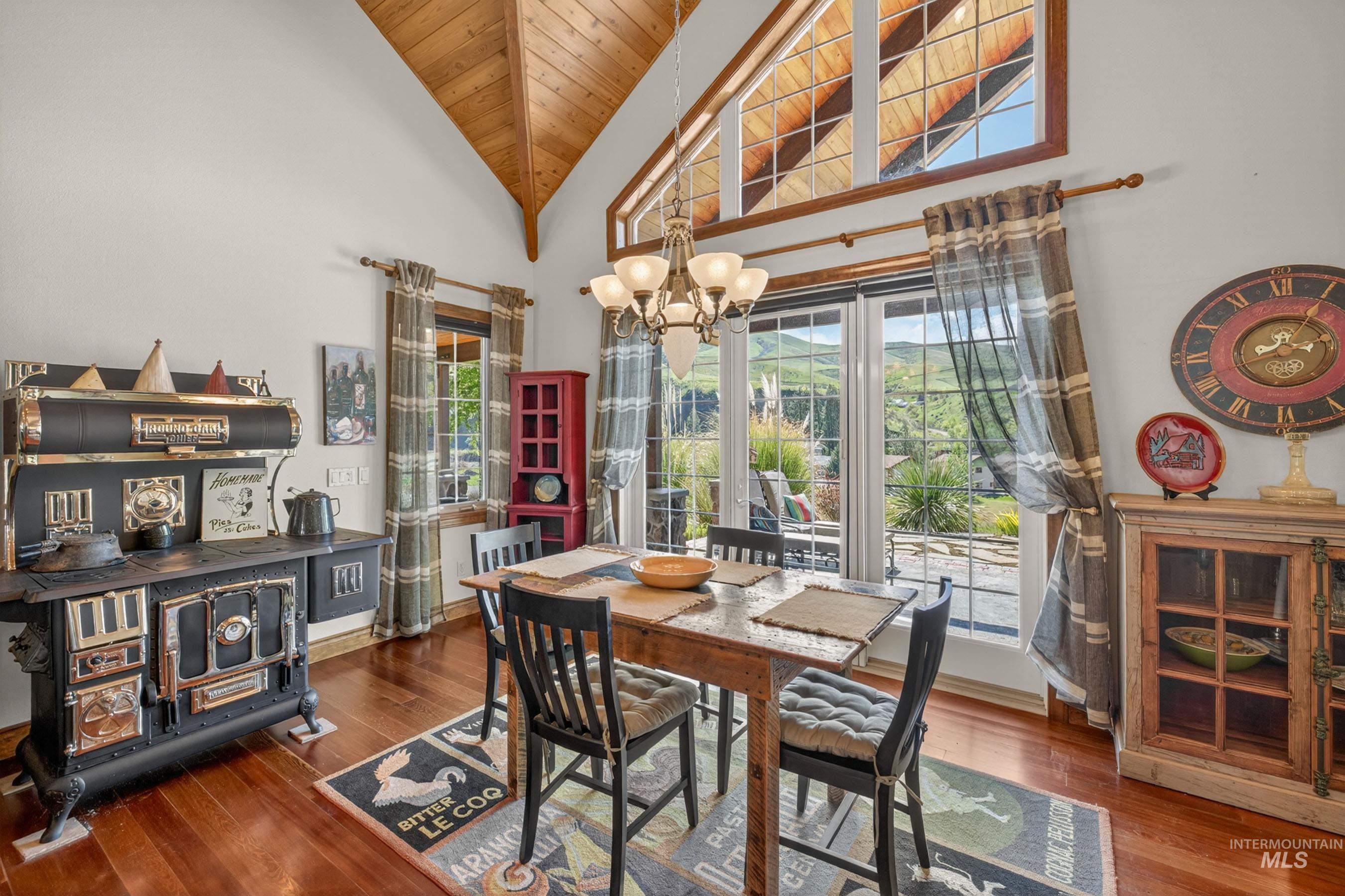 113 Deford Road White Bird, ID 83554 - Photo 13 of 49 Dining area featuring wood-finish flooring, a vaulted wood-paneled ceiling, and large windows