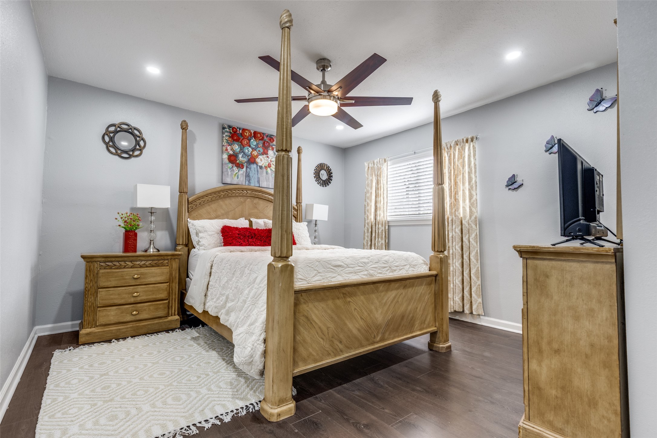 605 South Remington Drive Angleton, TX 77515 - Photo 15 of 25 a bedroom with a bed and a chandelier