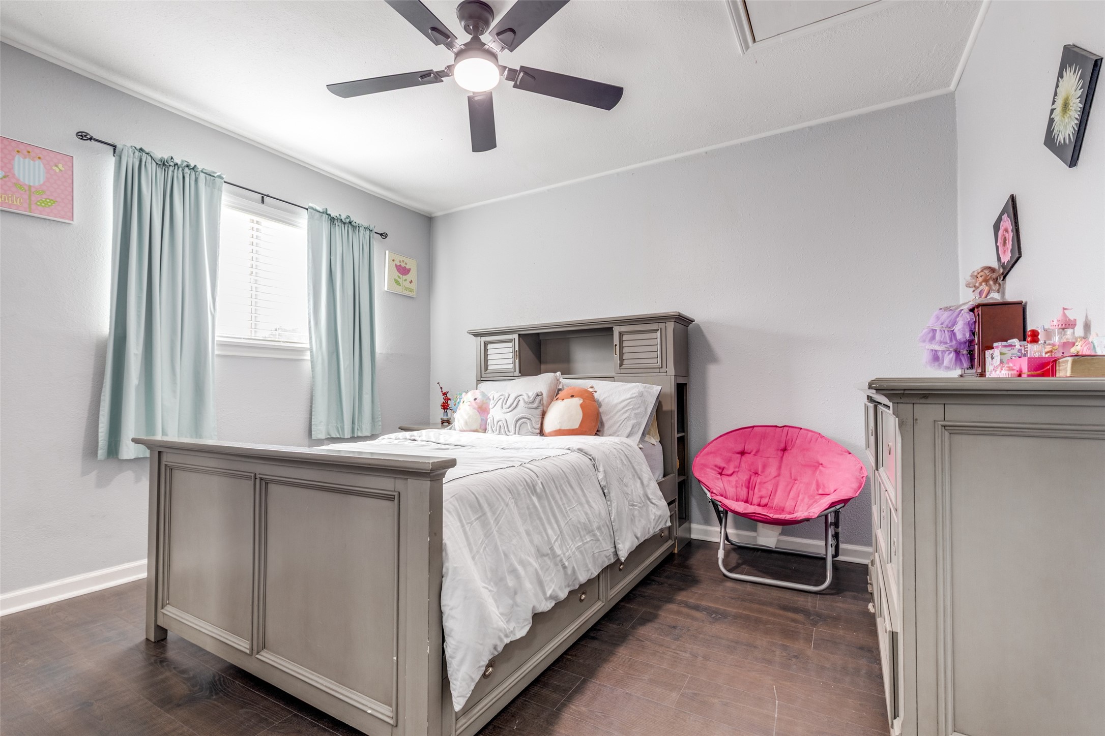 605 South Remington Drive Angleton, TX 77515 - Photo 20 of 25 a bedroom with a bed and chandelier