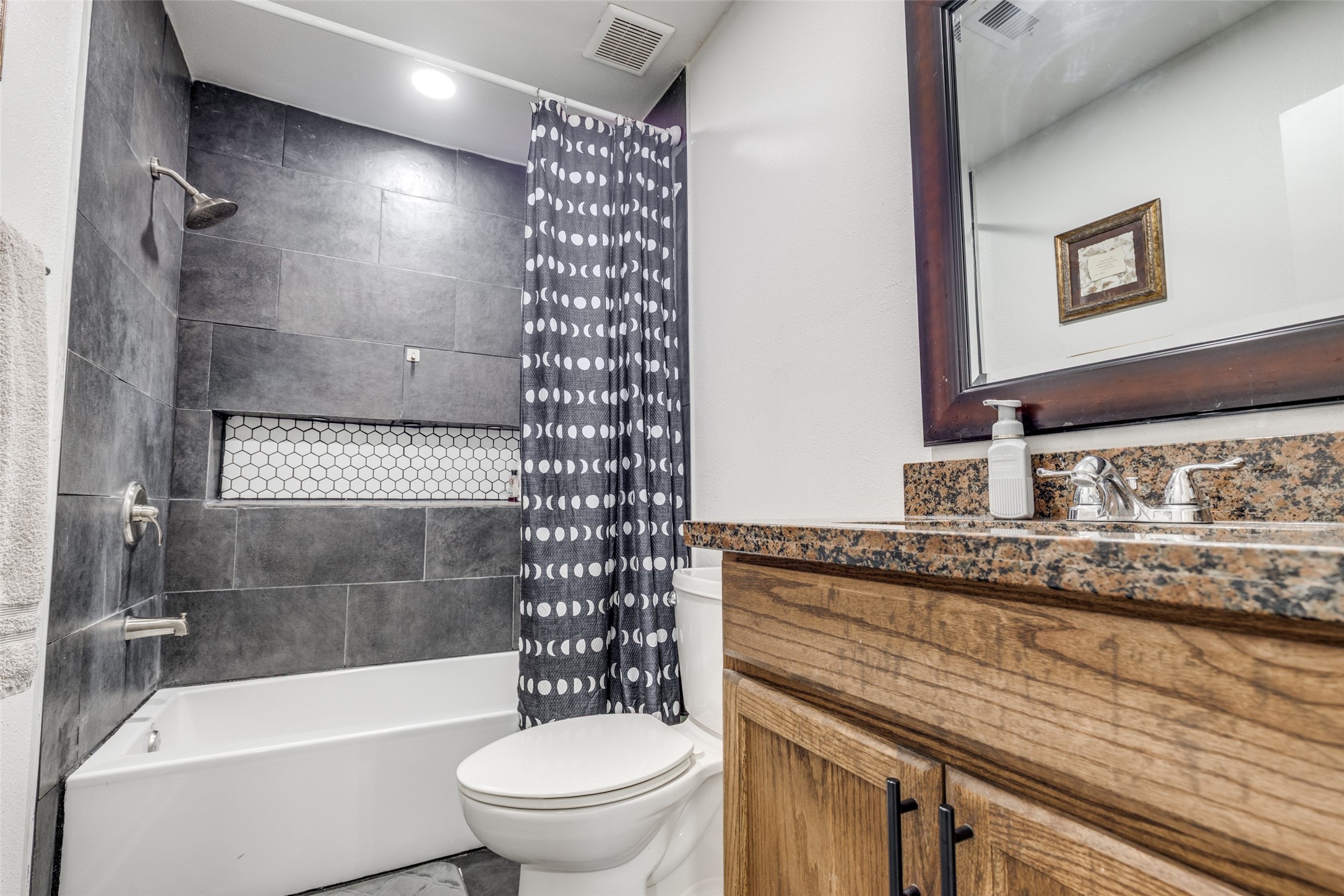605 South Remington Drive Angleton, TX 77515 - Photo 21 of 25 a bathroom with a granite countertop bathtub shower sink mirror and toilet