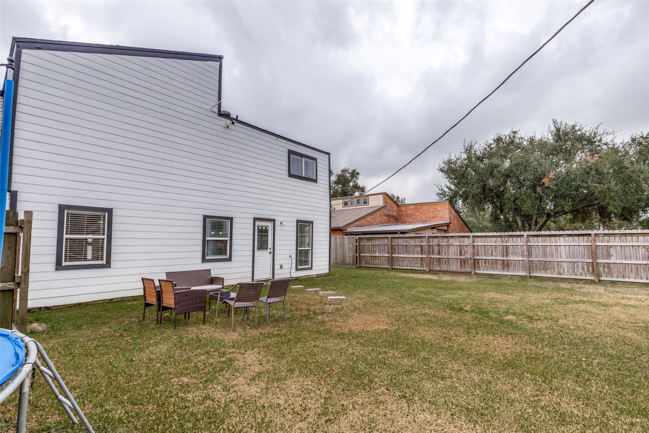 605 South Remington Drive Angleton, TX 77515 - Photo 22 of 25 a backyard of a house with table and chairs